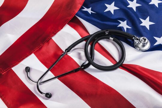 Close-up Photo Of Stethoscope On American USA Flag